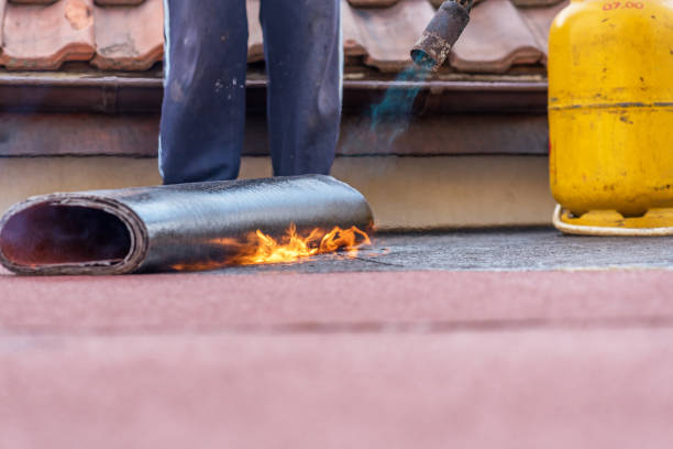 roll roofing installation with propane blowtorch during construction works.